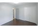 Bedroom with dark hardwood floors, closet, and neutral walls, providing a comfortable and inviting space at 5252 Biffle Rd, Stone Mountain, GA 30088