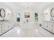 Luxurious bathroom featuring dual vanities, a soaking tub, and elegant lighting fixtures at 675 Old Lathemtown Rd, Canton, GA 30115