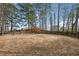 Fenced equestrian ring with mature trees in background at 675 Old Lathemtown Rd, Canton, GA 30115