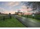 Estate at dusk with long drive and fenced perimeter at 675 Old Lathemtown Rd, Canton, GA 30115