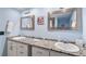 Bathroom featuring a double vanity with granite countertops and framed mirrors at 6851 Roswell Rd # M12, Sandy Springs, GA 30328