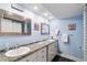 Bathroom featuring a double vanity with granite countertops and framed mirrors at 6851 Roswell Rd # M12, Sandy Springs, GA 30328