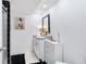 Bathroom featuring modern vanity with granite countertop, framed mirror, and black and white tile at 6851 Roswell Rd # M12, Sandy Springs, GA 30328