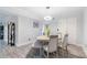 Elegant dining room with wood-look flooring, modern lighting, a round table and four chairs at 6851 Roswell Rd # M12, Sandy Springs, GA 30328