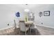Bright dining room with a round table, wood-look flooring, modern lighting, and neutral decor at 6851 Roswell Rd # M12, Sandy Springs, GA 30328
