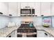 Close up of a well-appointed kitchen featuring granite counters, stainless steel appliances, and white subway tile backsplash at 6851 Roswell Rd # M12, Sandy Springs, GA 30328