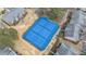 Aerial view of blue tennis courts with white lines, surrounded by lush greenery and residential buildings at 6851 Roswell Rd # M12, Atlanta, GA 30328