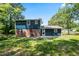 A view of the backyard and back exterior of this two-story home with blue siding and a brick foundation at 10664 Sandpiper Road Rd, Jonesboro, GA 30238