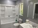 Well-lit bathroom featuring a shower-tub combo, neutral paint, and a white vanity with sink at 10664 Sandpiper Road Rd, Jonesboro, GA 30238