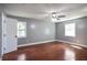 Bedroom featuring hardwood floors, ceiling fan, and bright windows at 10664 Sandpiper Road Rd, Jonesboro, GA 30238