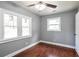 Bedroom with a ceiling fan, hardwood floors, two bright windows and white trim at 10664 Sandpiper Road Rd, Jonesboro, GA 30238