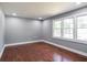 Bright bedroom with hardwood floors, neutral paint, and large windows for natural light at 10664 Sandpiper Road Rd, Jonesboro, GA 30238