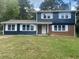 Charming split-level home featuring a brick accent, fresh paint, and bright white shutters and trim at 10664 Sandpiper Road Rd, Jonesboro, GA 30238