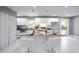 Modern kitchen with a large center island, white cabinets, and marble countertops at 10664 Sandpiper Road Rd, Jonesboro, GA 30238