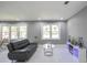 Bright living room features marble floors, gray walls and two large windows at 10664 Sandpiper Road Rd, Jonesboro, GA 30238