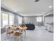 Open-concept living and dining area boasts sleek marble floors, gray walls and a wet bar at 10664 Sandpiper Road Rd, Jonesboro, GA 30238