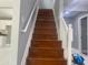 Wooden staircase with white railings leading up to the second floor at 10664 Sandpiper Road Rd, Jonesboro, GA 30238