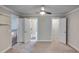 Spacious bedroom with multiple doorways, a ceiling fan and neutral carpeting throughout at 1881 Holman Rd, Hoschton, GA 30548