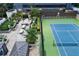 Aerial view of tennis court, patio seating, and manicured landscaping at 3445 Stratford Ne Rd # 2403, Atlanta, GA 30326