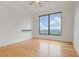 Comfortable bedroom featuring hardwood floors, a ceiling fan, and scenic city views at 3445 Stratford Ne Rd # 2403, Atlanta, GA 30326