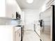 Modern white galley kitchen features stainless steel appliances, countertop and herringbone backsplash at 3445 Stratford Ne Rd # 2403, Atlanta, GA 30326