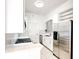 Modern kitchen with stainless steel appliances, herringbone backsplash and ample counter space at 3445 Stratford Ne Rd # 2403, Atlanta, GA 30326