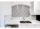 Close up of modern kitchen sink with decorative black and white patterned backsplash at 3445 Stratford Ne Rd # 2403, Atlanta, GA 30326