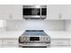 Close up of updated kitchen features modern stainless steel oven and herringbone backsplash at 3445 Stratford Ne Rd # 2403, Atlanta, GA 30326