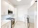 Modern galley kitchen features stainless steel appliances and all-white cabinets at 3445 Stratford Ne Rd # 2403, Atlanta, GA 30326