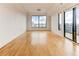 Spacious living room with hardwood floors, large windows, and sliding doors to balcony at 3445 Stratford Ne Rd # 2403, Atlanta, GA 30326