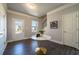 Entryway featuring dark hardwood floors, a staircase, a window, and a view of the outside at 8486 Big Cedar Ct, Riverdale, GA 30274