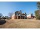 Back of a multi-story house featuring a wooden deck with stairs overlooking the backyard at 1030 Silver Thorne Dr, Loganville, GA 30052