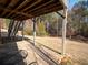 Back porch with outdoor furniture and stairs leading to a large, grassy backyard surrounded by trees at 1030 Silver Thorne Dr, Loganville, GA 30052