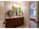 Updated bathroom with dark wood vanity, marble countertop, and greenery accents at 1030 Silver Thorne Dr, Loganville, GA 30052