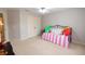 Cozy bedroom with pink striped bedding and a view to the hallway at 1030 Silver Thorne Dr, Loganville, GA 30052