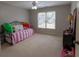 Bright bedroom with a daybed and black dresser illuminated by natural light at 1030 Silver Thorne Dr, Loganville, GA 30052