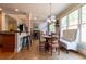 Bright dining area featuring hardwood floors, breakfast bar, and multiple dining tables, perfect for gatherings at 1030 Silver Thorne Dr, Loganville, GA 30052