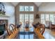 Elegant dining room boasting a stone fireplace, high ceilings, and picturesque views through large windows at 1030 Silver Thorne Dr, Loganville, GA 30052