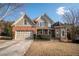 Charming brick and stone two-story home with manicured lawn and attached two car garage at 1030 Silver Thorne Dr, Loganville, GA 30052