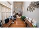 Welcoming foyer with hardwood floors, bench seating, and decorative windmill wall decor at 1030 Silver Thorne Dr, Loganville, GA 30052