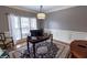 Cozy home office with classic desk, chair, and rug illuminated by a decorative light fixture at 1030 Silver Thorne Dr, Loganville, GA 30052