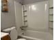 Clean bathroom with a tub and shower combo with built-in shelving at 10836 Mallard Dr, Jonesboro, GA 30238