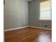 Bedroom featuring hardwood floors, neutral paint, and bright window at 10836 Mallard Dr, Jonesboro, GA 30238