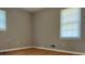 A sun-drenched bedroom featuring hardwood floors and modern paint at 10836 Mallard Dr, Jonesboro, GA 30238