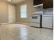 Eat-in kitchen featuring white appliances, tiled floor and ample natural light at 10836 Mallard Dr, Jonesboro, GA 30238