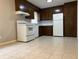 Kitchen with white appliances and dark cabinets offering generous storage space at 10836 Mallard Dr, Jonesboro, GA 30238