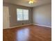 Cozy living room with hardwood floors and natural light through a window at 10836 Mallard Dr, Jonesboro, GA 30238