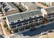 Aerial view of townhouses with brick facades, covered porches, landscaping, and parking at 127 Harlow Cir, Roswell, GA 30076