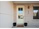 Inviting front door with glass panel, brick surround, and decorative details at 127 Harlow Cir, Roswell, GA 30076