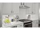 Beautiful kitchen with herringbone backsplash, modern appliances, and ample counter space at 127 Harlow Cir, Roswell, GA 30076